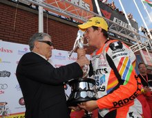 Thumbnail of TT legends and multiple winners Geoff Duke and John McGuinness inspect the historic Senior TT trophy