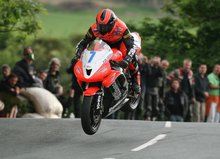 Thumbnail of Ryan Farquhar leaping Ballaugh Bridge during practice for the 2008 TT