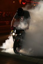 Thumbnail of A biker performs a burnout during TT 2008