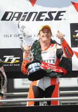 Thumbnail of John McGuinness shows off the Senior TT Trophy after taking his 14th TT victory in 2008