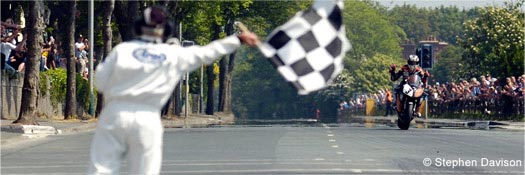 TT winner John McGuinness crossing the finish line - Copyright Stephen Davidson