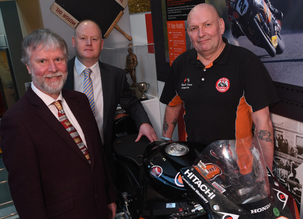 Director of Manx National Heritage Edmund Southworth, Rob Callister MHK and Robert Crane, Chairman of the Isle of Man TT Marshals Association pose with John McGuinness's record breaking 2007 Fireblade at the Manx Museum.