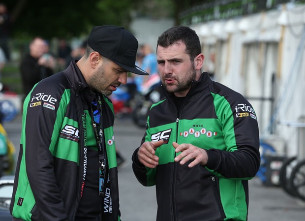 Michael Dunlop talks with his Paton teammate ahead of the start of the qualifying session