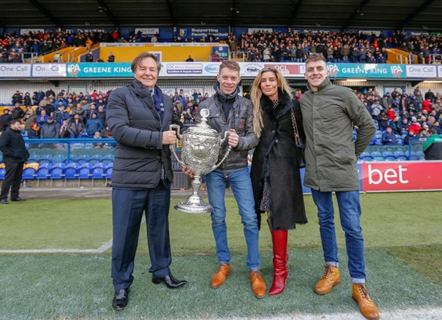 Ben and Tom Birchall hand the Fred Craner Trophy over to John and Carolyn Radford of One Call Insurance, for safe keeping at the Mansfield Town FC home ground.