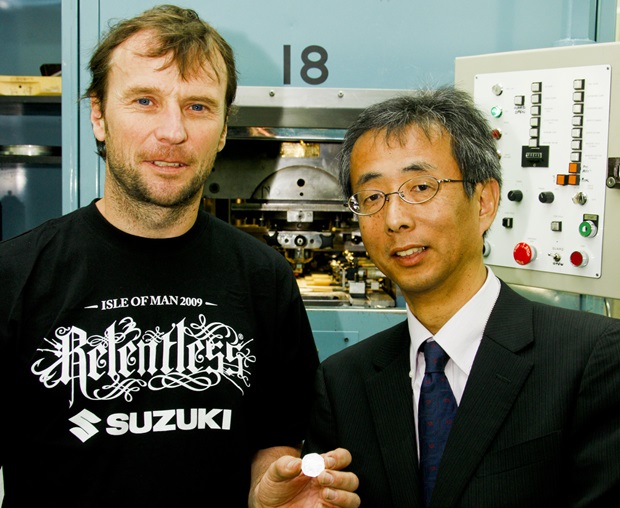 Bruce Anstey and Yasuharu Osawa with the Suzuki 50th anniversary 50p coin
