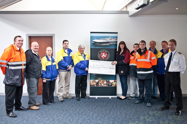 Nicola Thompson , Passenger Services Officer, presented Dr David Stephens and Motorsport Medical Volunteers with the cheque, pictured with crew members of the Ben-my-Chree and Manannan