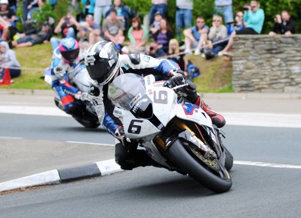 Michael Dunlop won the 2014 PokerStars Senior TT riding a Hawk Racing BMW S 1000 RR super bike. Here he leads Guy Martin into Governor's Bridge dip