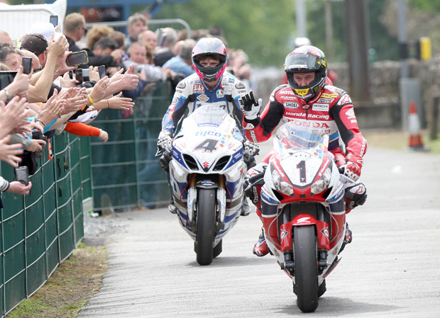 As they finish the Senior TT John McGuinness and Guy Martin are greeted by VIP ticket holders
