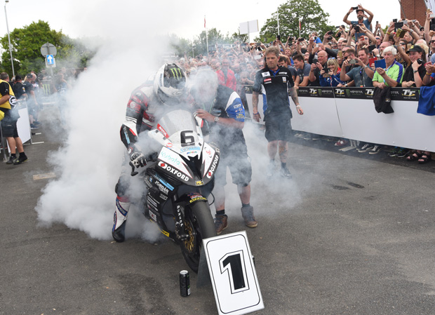 Michael Dunlop lights up the rear tyre to celebrate his record-breaking victory in the Senior TT. Credit Dave Kneale / iomtt.com