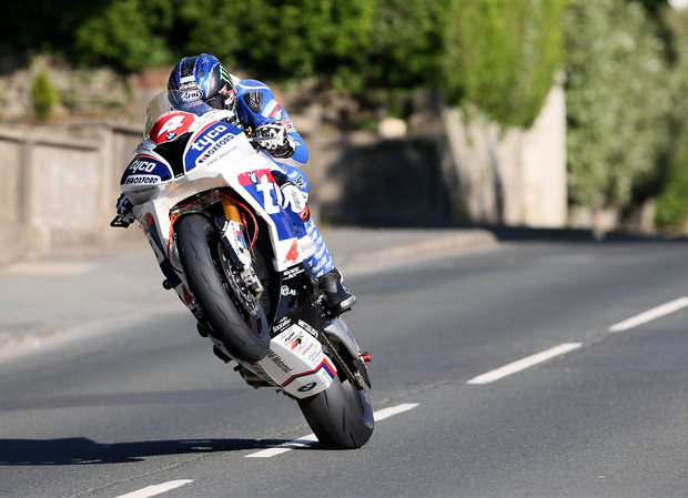 Ian Hutchinson took his Tyco BMW Superstock bike round the Isle of Man TT Mountain Course in a new unofficial absolute record speed of 132.803mph