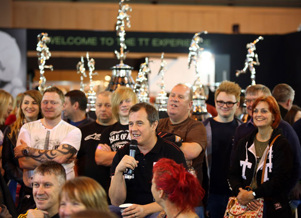 John McGuinness, surrounded by the familiar TT trophies, answers questions from fans at Motorcycle Live