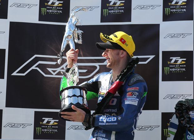 Ian Hutchinson lifts the winner's trophy for the RST Superbike TT Race - his fifteenth TT win