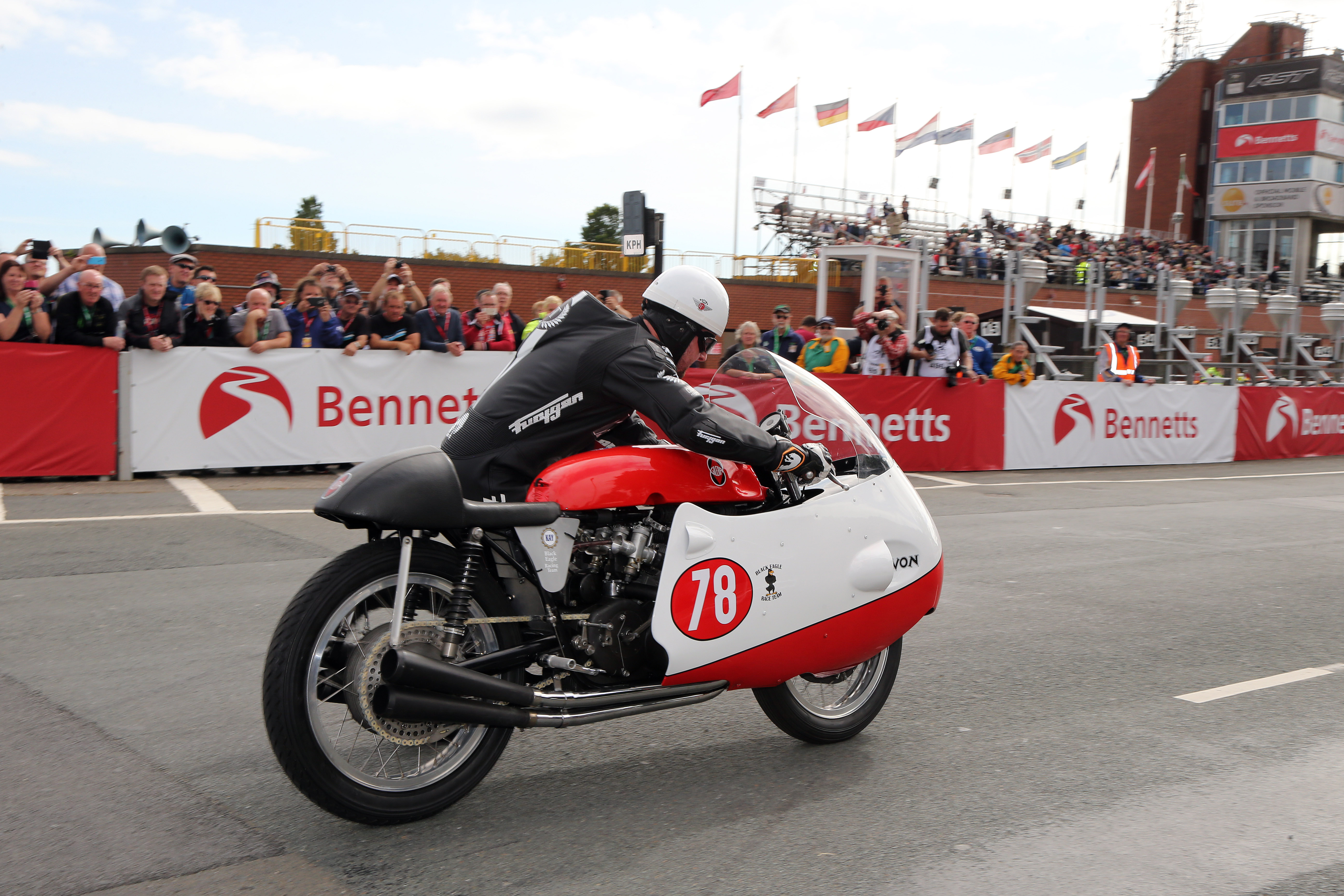 Michael Dunlop pushes the Gilera 500-4 into life to start his tribute lap to commemorate 60 years of Bob McIntyre's 100mph. Photo Dave Kneen / Pacemaker Press Intl.