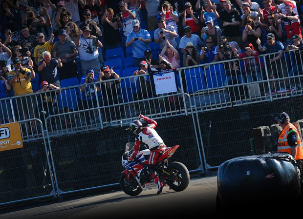 John McGuinness salutes the crowd on the Noble's South grandstand